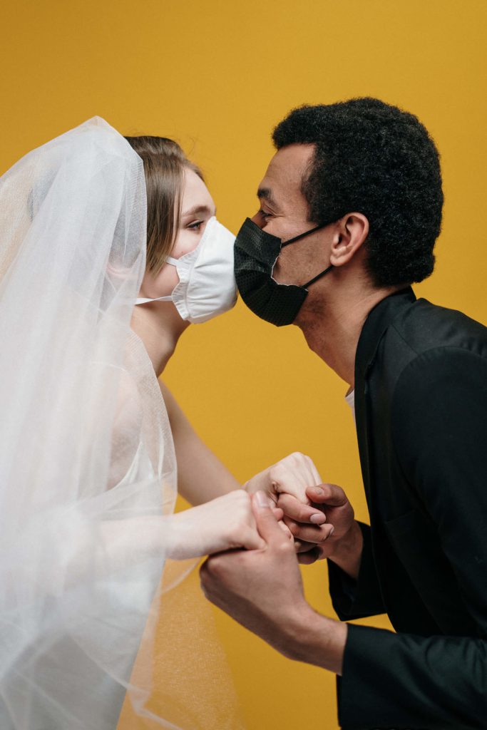 man in black suit jacket holding woman in white wedding 3951880 scaled 1