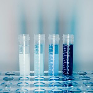 Close-up of test tubes filled with colorful liquids in a laboratory setting.